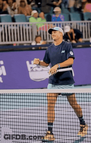 Man Holding Tennis Racquet In New Balance Shirt GIF