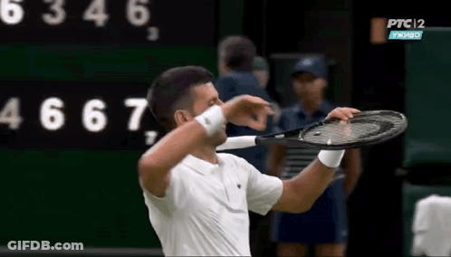 Man Holding Tennis Racquet Near PTC Scoreboard GIF