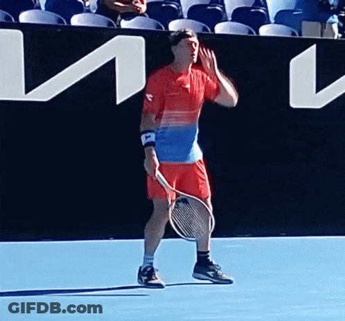 Man Holding Tennis Racquet On Blue Court GIF