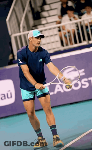 Man Holding Tennis Racquet On Court Saying New Balance GIF