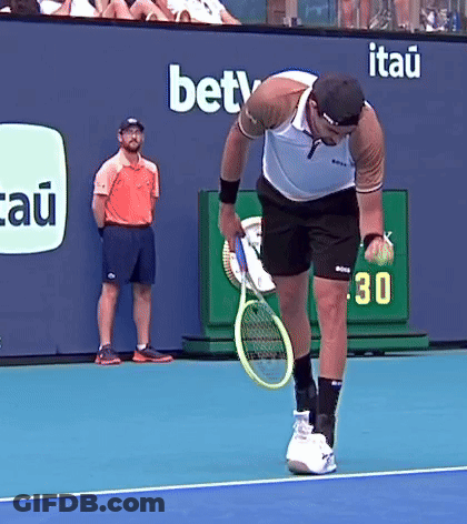 Man Holding Tennis Racquet On Court With BETV Ad GIF