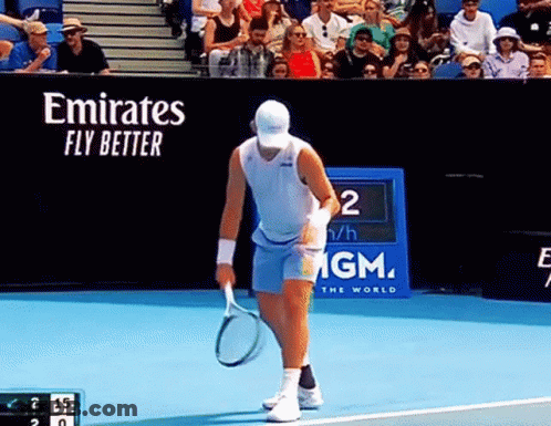Man Holding Tennis Racquet On Court With Emirates Fly Better Banner GIF