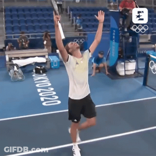 Man Holding Tennis Racquet On Court With Tokyo 2020 GIF