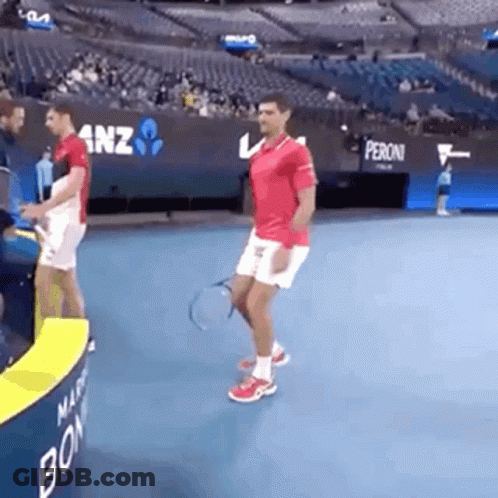 Man Holding Tennis Racquet On Tennis Court GIF