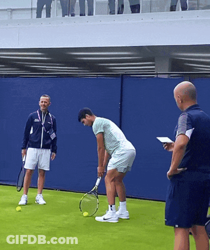 Man Holding Tennis Racquet With Another Man GIF