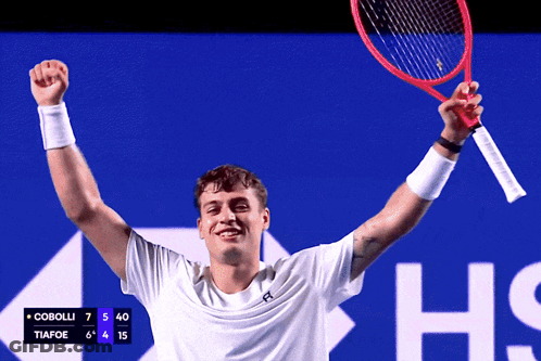 Man Holding Tennis Racquet With Scoreboard Cobolli Tiafoe GIF