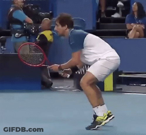 Man Holding Tennis Racquet Woman In Stands GIF