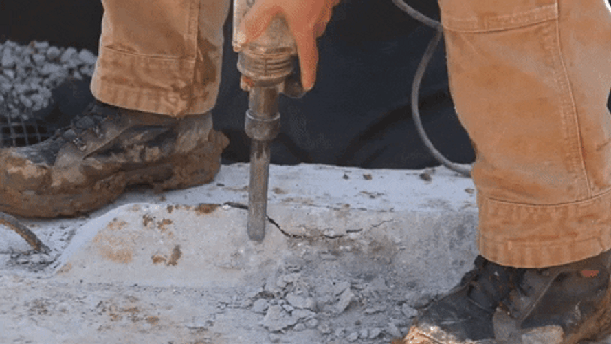 Man Holding The Head Of A Jackhammer GIF