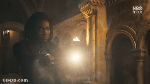 Man Holding Torch In Dark Room With HBO Max Logo GIF
