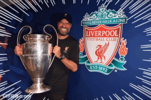 Man Holding Trophy And Liverpool Football Club Sign GIF