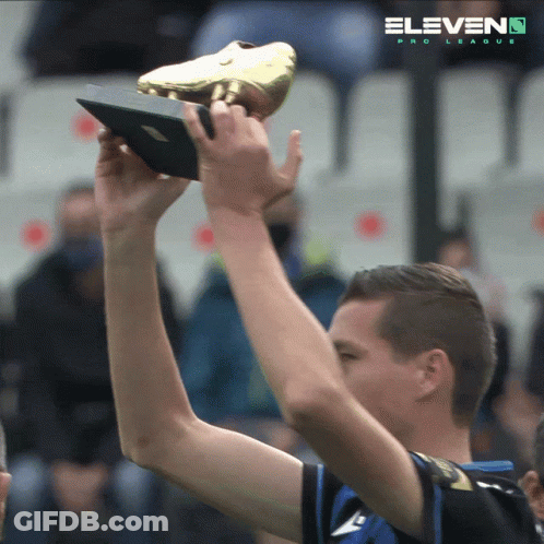 Man Holding Trophy Behind Eleven Pro League Logo GIF