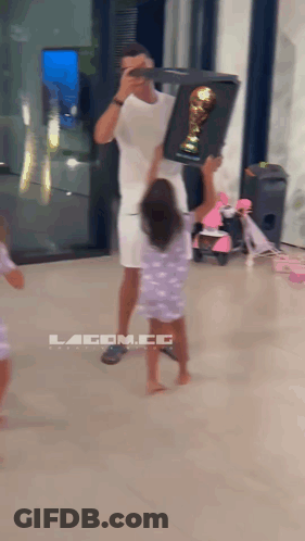 Man Holding Trophy Girl Reaching For Lacom.co Sign GIF
