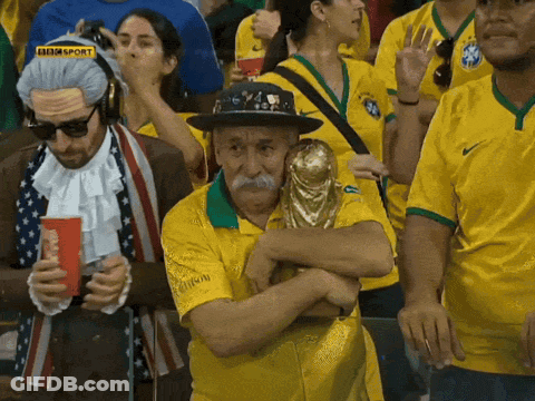 Man Holding Trophy In Crowd With BBC Sport Logo GIF