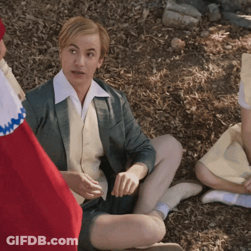 Man Holding Trophy In Front Of Rheen Sign GIF