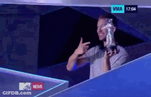 Man Holding Trophy In Front Of TV Saying VMA GIF