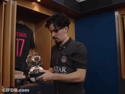 Man Holding Trophy In Locker Room With Number 17 Shirt GIF