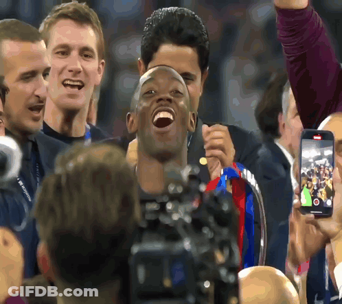 Man Holding Trophy Laughing In Front Of Group GIF