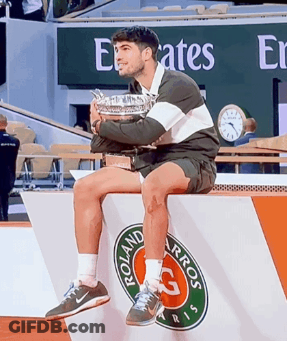 Man Holding Trophy On Podium Emirates Sign GIF