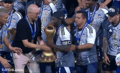 Man Holding Trophy Saying EC GIF