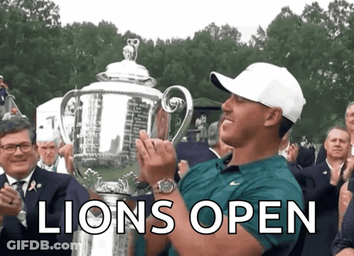 Man Holding Trophy Saying Lions Open GIF