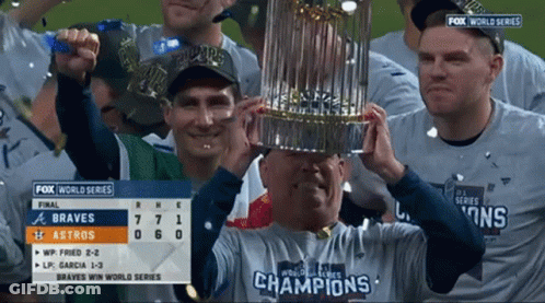 Man Holding Trophy Wearing Champions Shirt GIF