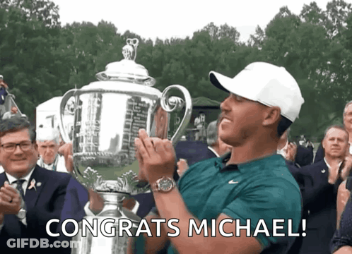 Man Holding Trophy With Congrats Michael GIF