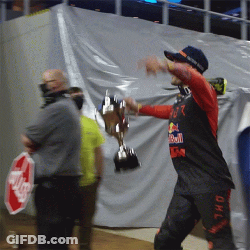 Man Holding Trophy With Red Bull Shirt GIF