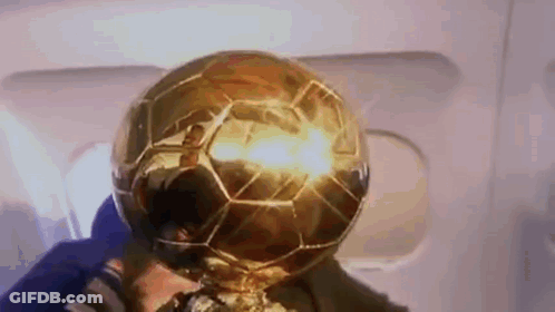 Man Holding Trophy With Soccer Ball GIF
