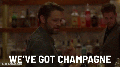 Man Holding Two Bottles Of Champagne Saying We've Got Champagne GIF