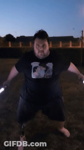Man Holding Two Lightsabers GIF