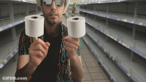 Man Holding Two Rolls Of Toilet Paper In Empty Store GIF