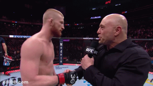Man Holding UFC Microphone Talks To Another Man GIF
