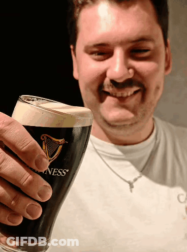 Man Holding Up Glass Of Guinness GIF