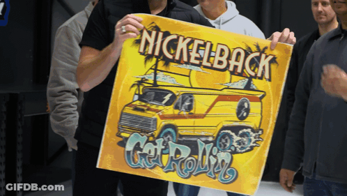 Man Holding Up Nickelback Poster GIF