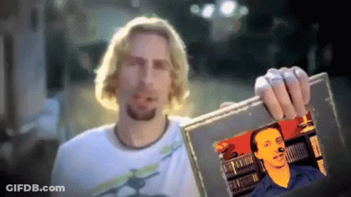 Man Holding Up Picture Of Bearded Man GIF