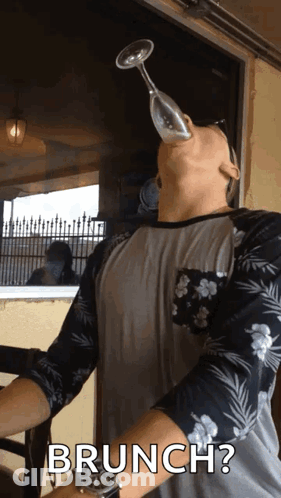 Man Holding Wine Glass In Mouth GIF