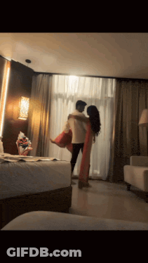 Man Holding Woman In Arms In Room GIF