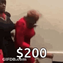 Man Holding Woman In Red Dress Says $200 With Man Behind GIF