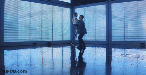 Man Holding Woman In Room With Windows GIF