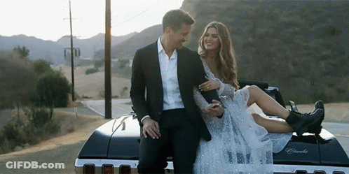 Man Holding Woman On Back Of Car GIF