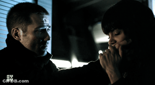 Man Holding Woman's Hand In Front Of Su Fy Screen GIF