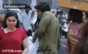 Man Holding Woman's Hand Walking Down Street GIF