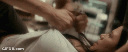 Man Holding Woman's Shirt On Bed GIF