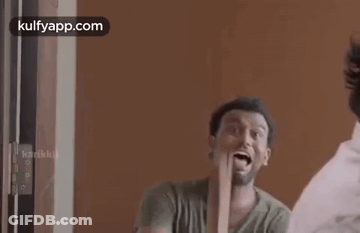 Man Holding Wood In Front Of Mirror GIF