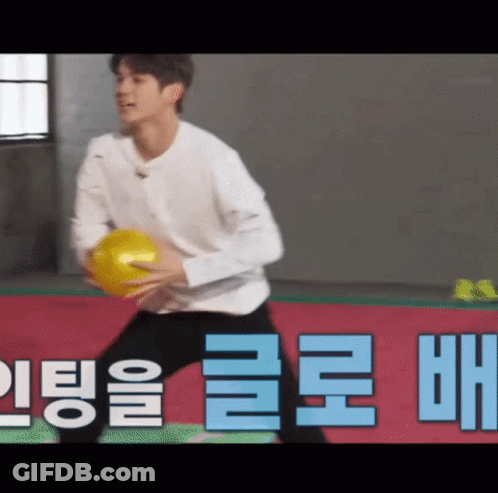 Man Holding Yellow Ball GIF