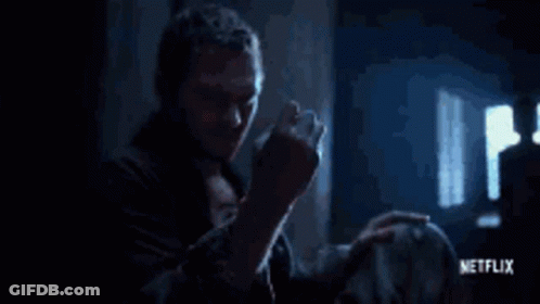 Man Holding Yellow Object In Dark Room GIF