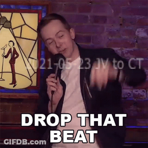 Man Holds Microphone And Says Drop That Beat GIF