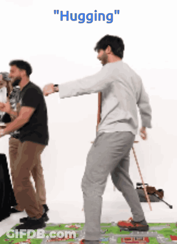 Man Hugging Another Man On Rug GIF