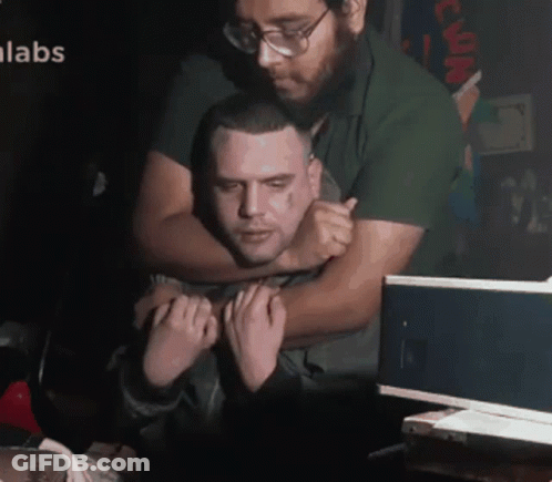 Man Hugging Another Man With Labs GIF