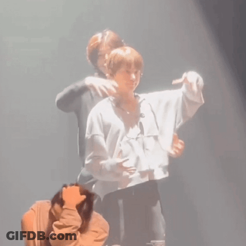 Man Hugging Another On Stage GIF